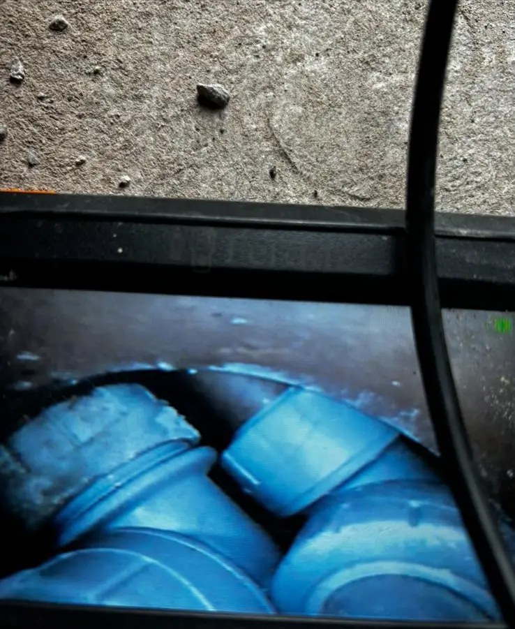 Endoscopic camera screen showing blue pipework